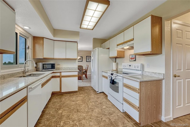 43793 Buckskin Rd, Parker, CO 80138 - kitchen featuring white appliances, under cabinet range hood, white cabinetry, and light stone counters