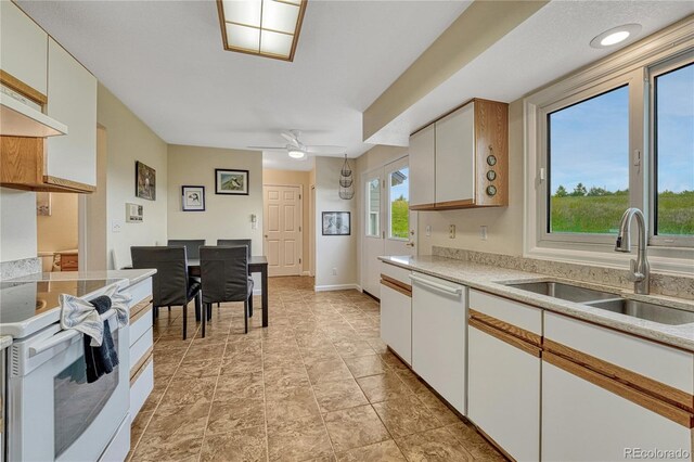 43793 Buckskin Rd, Parker, CO 80138 - kitchen featuring white appliances, light countertops, ceiling fan, white cabinetry, and light stone finish floors