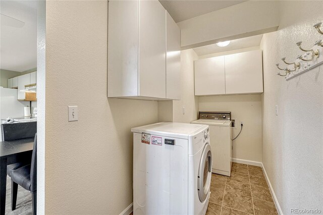 43793 Buckskin Rd, Parker, CO 80138 - laundry room featuring washer and dryer, a textured wall, and cabinet space