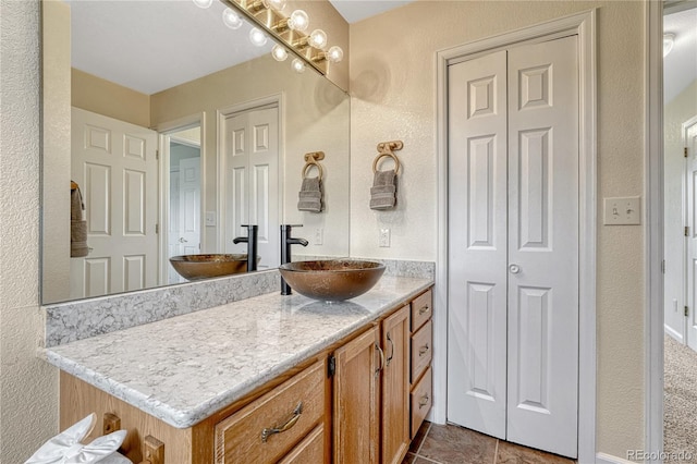 43793 Buckskin Rd, Parker, CO 80138 - bathroom with vanity, a closet, a textured wall, and tile patterned floors