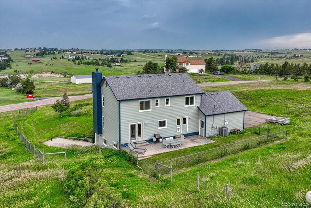 43793 Buckskin Rd, Parker, CO 80138 - back of property featuring a chimney, a patio area, entry steps, a shingled roof, and a fenced backyard