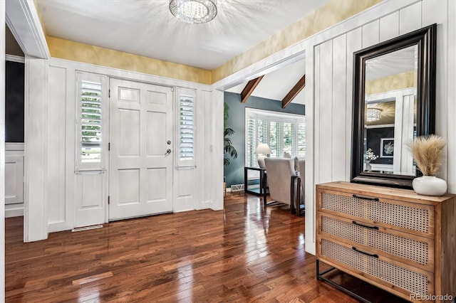 foyer entrance featuring dark hardwood / wood-style flooring, an inviting chandelier, and plenty of natural light