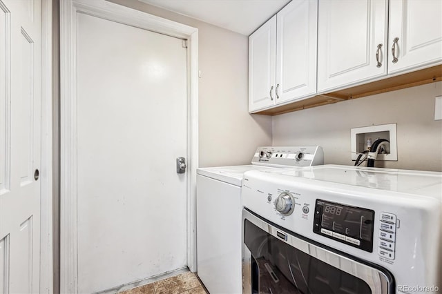 washroom featuring separate washer and dryer and cabinets