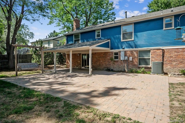 rear view of property with central AC and a patio area