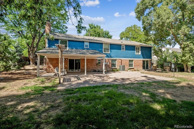 back of property with central AC unit and a patio area