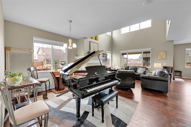 misc room with hardwood / wood-style floors and an inviting chandelier