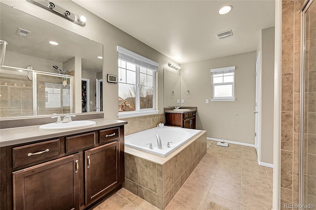 bathroom with tile patterned floors, vanity, and separate shower and tub