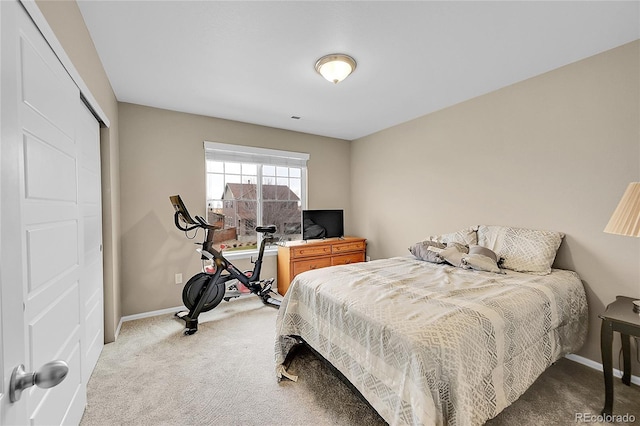 bedroom with light carpet and a closet