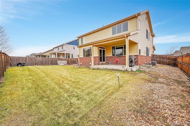 rear view of house featuring a yard, a patio, and central air condition unit