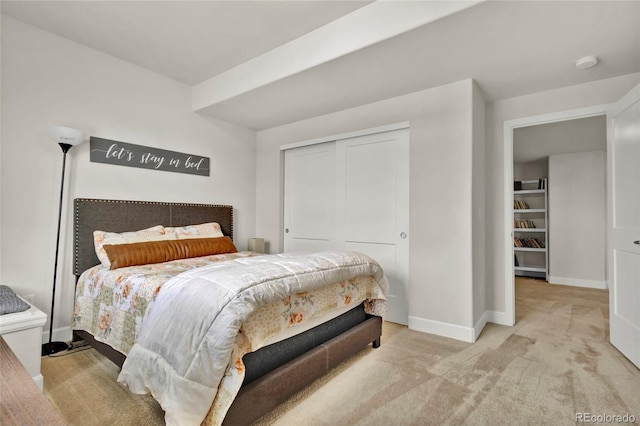 bedroom featuring light carpet and a closet