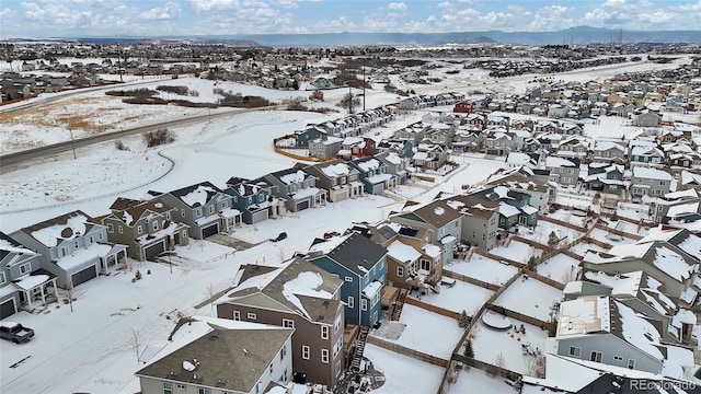 snowy aerial view with a mountain view