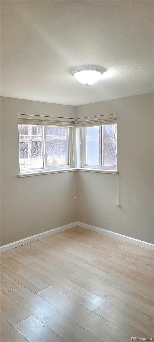 empty room with light hardwood / wood-style floors