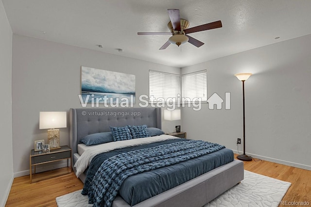 bedroom featuring hardwood / wood-style flooring, a textured ceiling, and ceiling fan