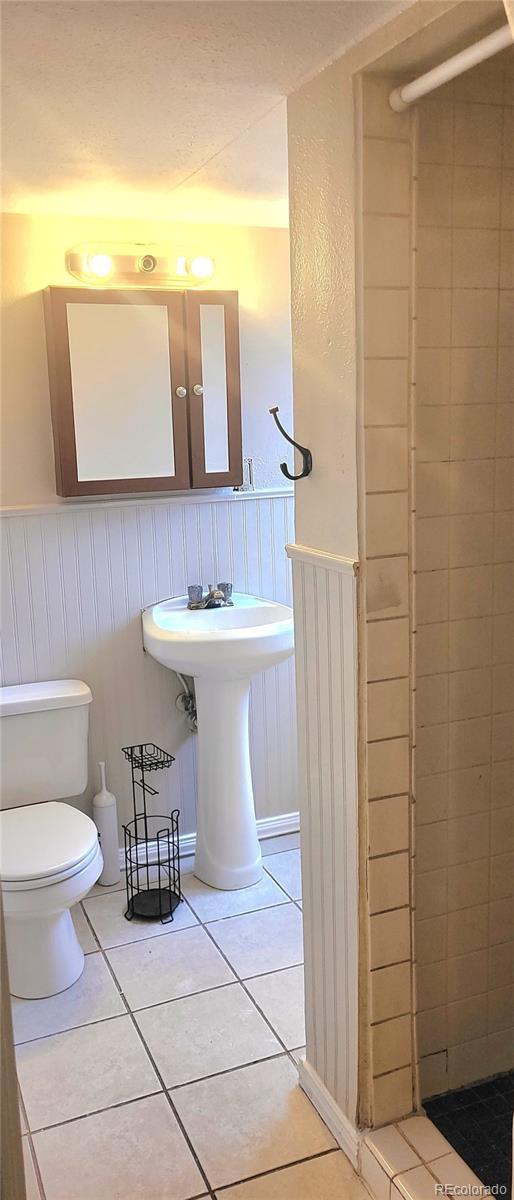 bathroom with sink, tile patterned floors, and toilet