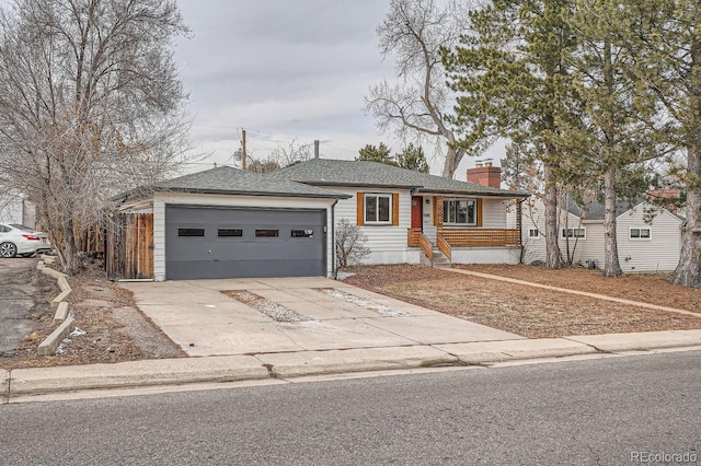 ranch-style home with driveway, a shingled roof, a garage, and a chimney