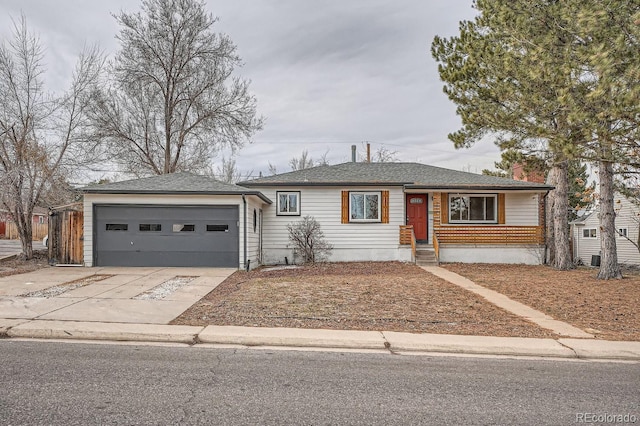 ranch-style home featuring a garage, a chimney, and concrete driveway