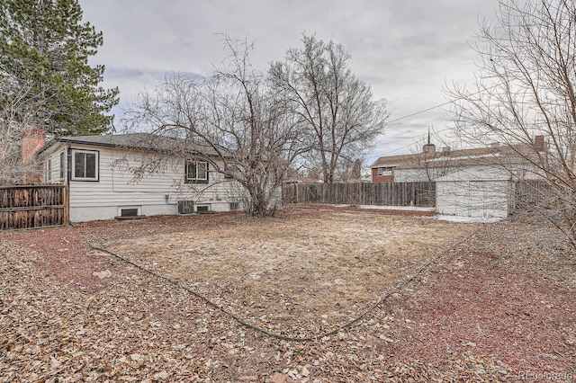 view of yard featuring fence and cooling unit