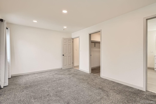 unfurnished bedroom with carpet floors, baseboards, and recessed lighting