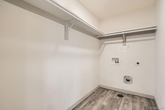 washroom with hookup for an electric dryer, laundry area, washer hookup, baseboards, and light wood-style floors