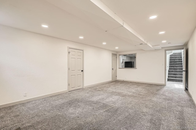 finished below grade area featuring carpet floors, stairs, baseboards, and recessed lighting