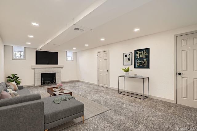 living room featuring a tile fireplace, recessed lighting, visible vents, baseboards, and carpet