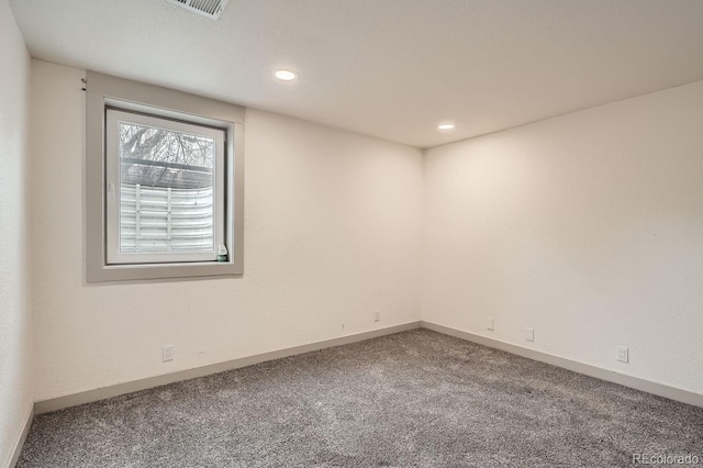 spare room with carpet, visible vents, baseboards, and recessed lighting