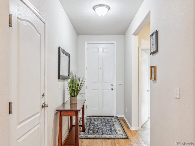 interior space with light wood finished floors and baseboards