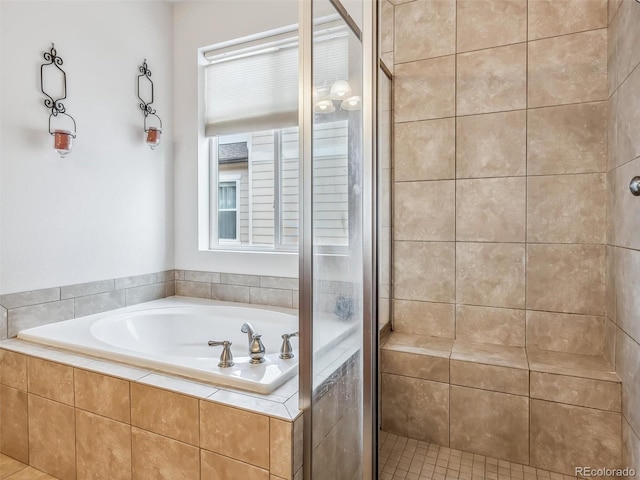 bathroom with a garden tub and a shower stall