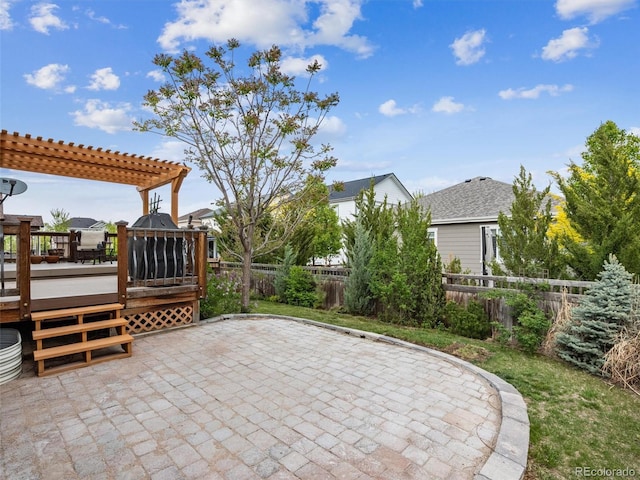 view of patio / terrace with a fenced backyard, a wooden deck, and a pergola