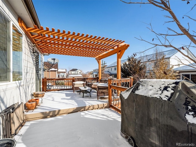 snow covered deck with a grill, a residential view, and a pergola