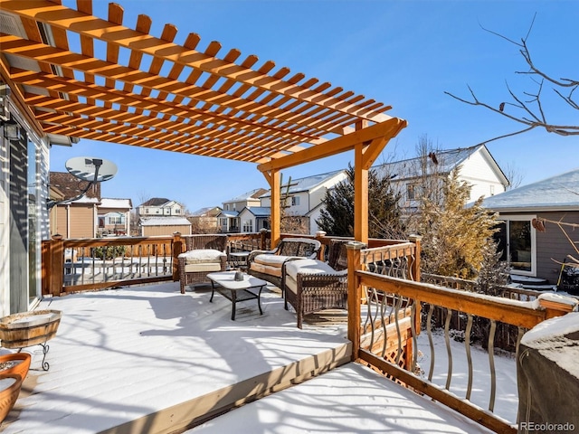 snow covered deck featuring a residential view and a pergola