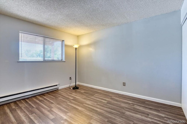 6007 Yarrow St Unit D, Arvada, CO 80004 - unfurnished room with wood finished floors, a textured ceiling, and baseboard heating