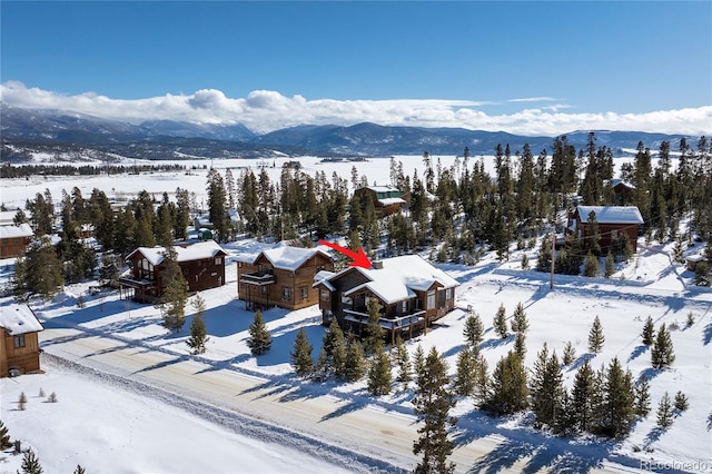 snowy aerial view with a mountain view