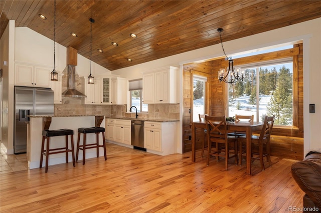 kitchen featuring tasteful backsplash, appliances with stainless steel finishes, white cabinets, and light stone counters