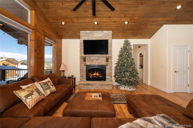 living room featuring hardwood / wood-style flooring, lofted ceiling, a fireplace, and wood ceiling