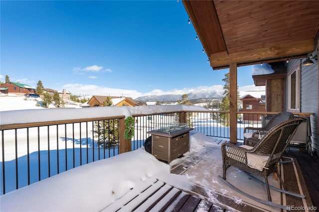 view of snow covered back of property