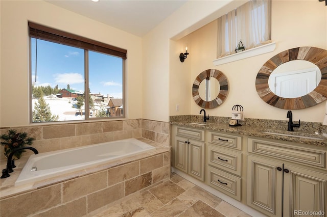 bathroom with vanity and tiled bath