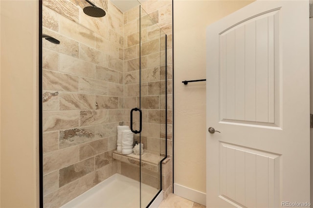 bathroom featuring a shower with shower door