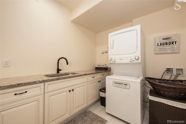 304 Gcr 424, Grand Lake, CO 80447 - washroom featuring cabinet space, light tile patterned flooring, a sink, and stacked washer and clothes dryer