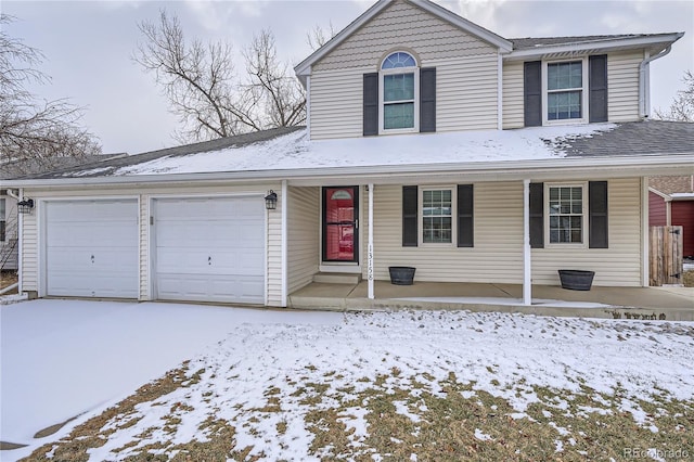 traditional-style home featuring covered porch and an attached garage