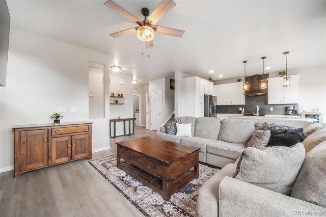 11524 Dewey St, Parker, CO 80138 - living area with baseboards, a ceiling fan, recessed lighting, and light wood-style flooring