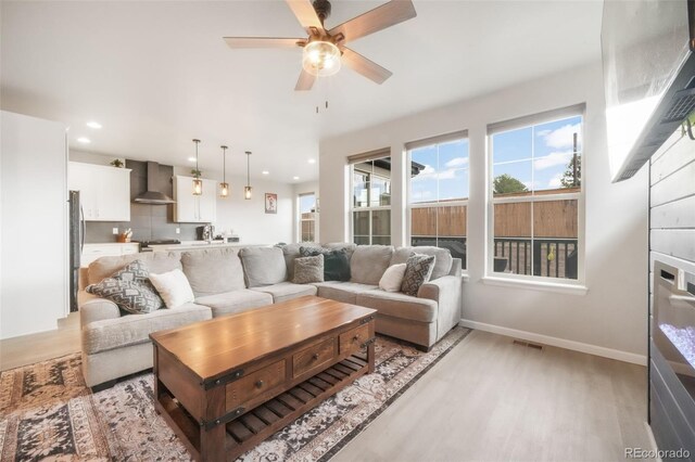 11524 Dewey St, Parker, CO 80138 - living room featuring visible vents, baseboards, ceiling fan, recessed lighting, and light wood-style flooring