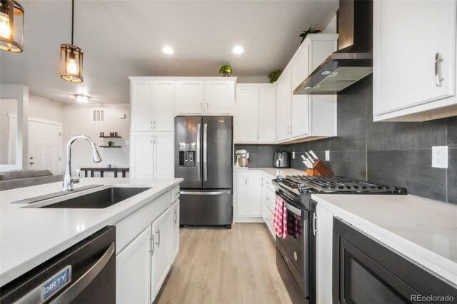 11524 Dewey St, Parker, CO 80138 - kitchen with a sink, light countertops, wall chimney range hood, and stainless steel appliances