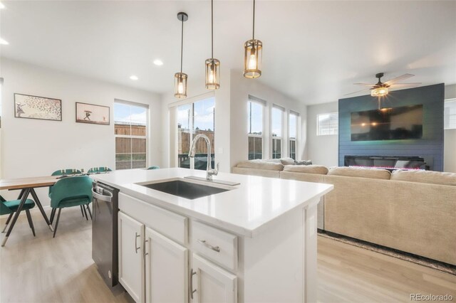 11524 Dewey St, Parker, CO 80138 - kitchen with a kitchen island with sink, a wealth of natural light, a sink, and light wood-type flooring