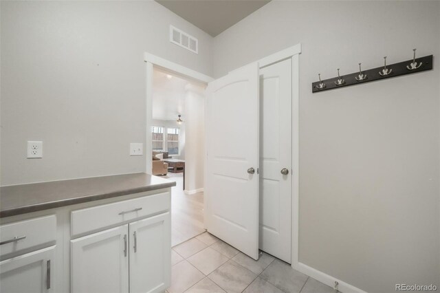 11524 Dewey St, Parker, CO 80138 - hall with light tile patterned floors, baseboards, and visible vents