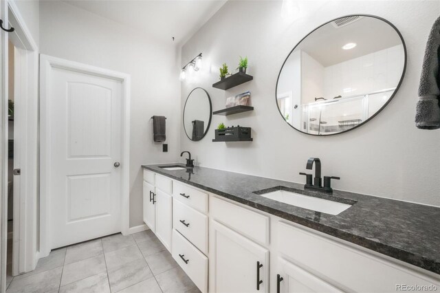 11524 Dewey St, Parker, CO 80138 - bathroom featuring double vanity, a sink, tile patterned floors, and a shower stall