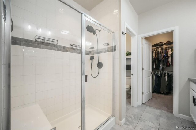 11524 Dewey St, Parker, CO 80138 - bathroom featuring a stall shower, toilet, and a spacious closet