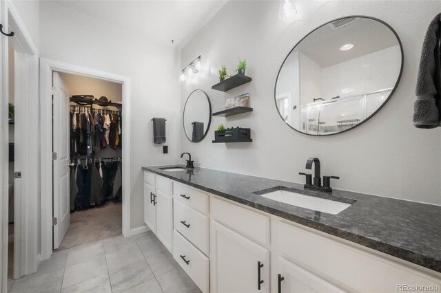 11524 Dewey St, Parker, CO 80138 - full bath featuring a sink, a stall shower, double vanity, and a spacious closet