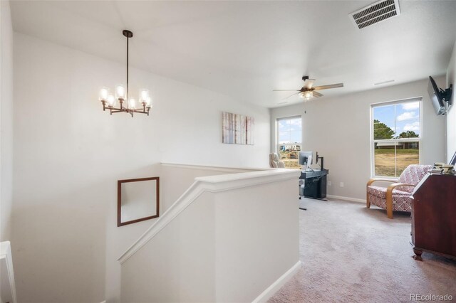 11524 Dewey St, Parker, CO 80138 - corridor featuring light carpet, a chandelier, baseboards, an upstairs landing, and visible vents