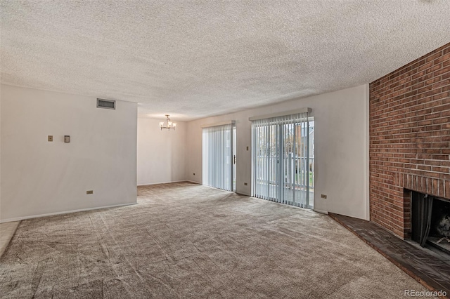 3436 S Locust St Unit D, Denver, CO 80222 - unfurnished living room with a chandelier, carpet floors, a fireplace, and a textured ceiling
